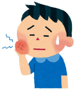 頬を押さえて歯の痛みをこらえる男性のイラスト